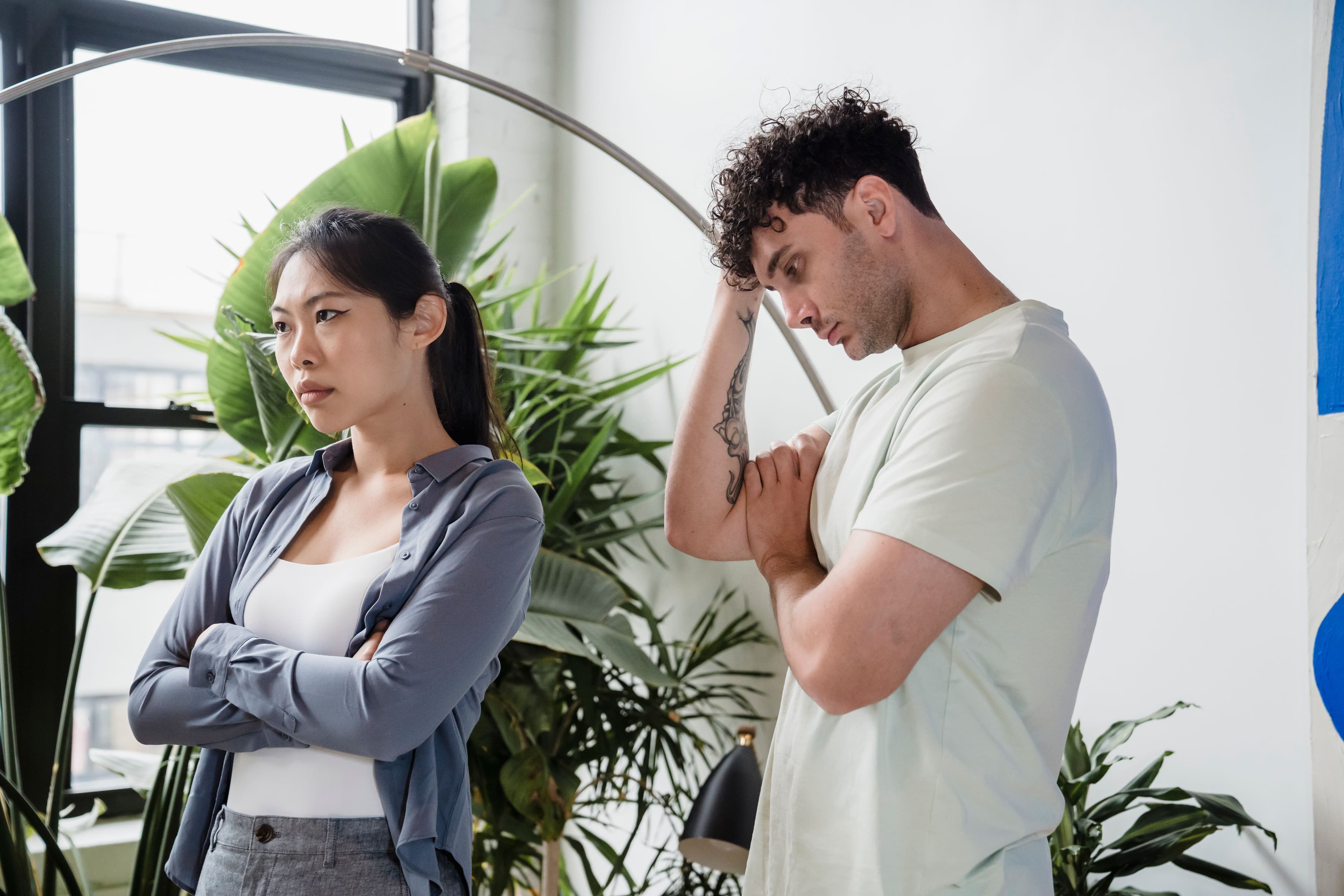 Couple standing apart after an argument and struggling to communicate